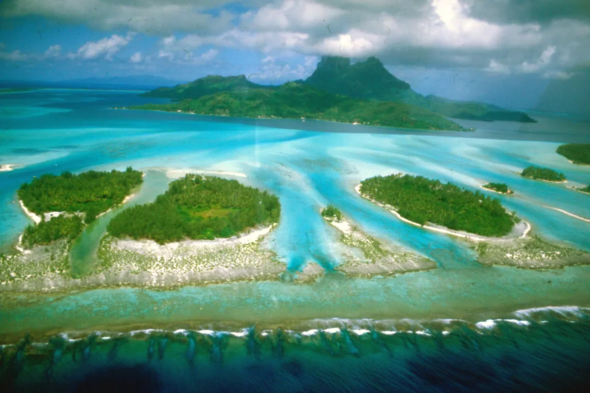 Aerial view of Bora Bora's turquoise lagoon and green motu islands